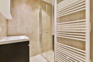 The luxury bathroom with brown tiled wall and floor