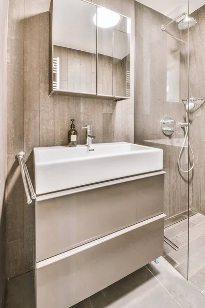 Modern bathroom in gray tones with appropriate equipment