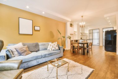 The interior of a studio apartment with a parquet floor