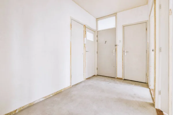 Puerta de un moderno apartamento con paredes blancas y suelo de parquet —  Fotos de Stock