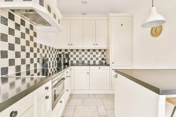 Kitchen with multicolored tiles on the walls