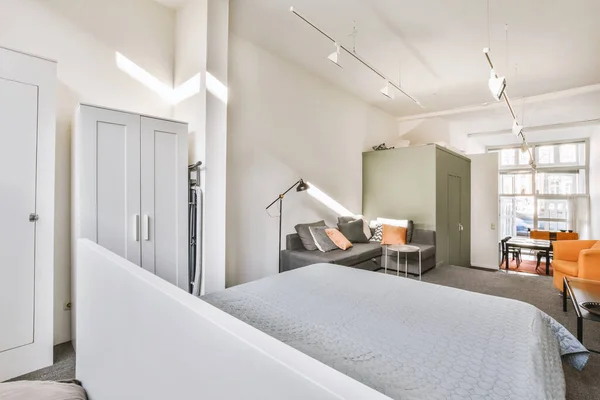 A small room in an open gray design with a sofa — Stock Photo, Image