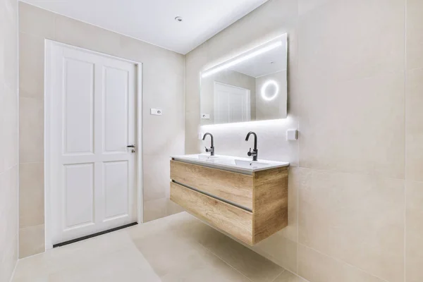 Sink and mirror near bathroom door