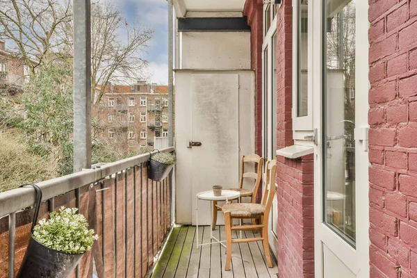 Narrow Brick Balcony Metal Railings Wooden Chair Door Glass Leads — 스톡 사진