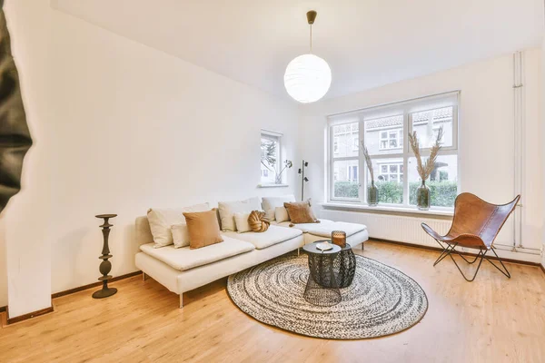 Stylish living-room with white sofa,white and brown pillows and decors