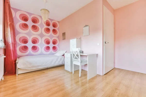 Bedroom with red pink painted wall and single bed,office table and chair
