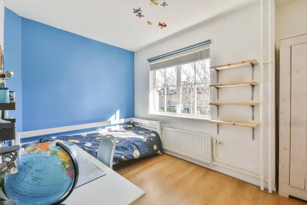 Interior of modern kid bedroom with bed and shelves with various toys at home