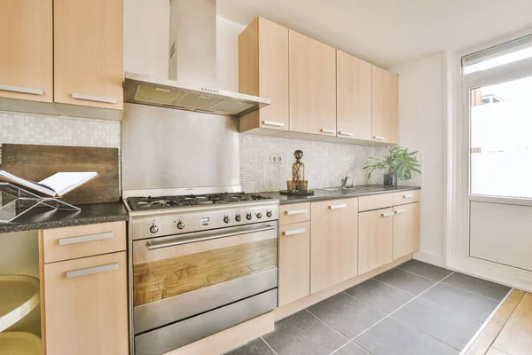 Cream colored kitchen cabinets in the kitchen room with house plants