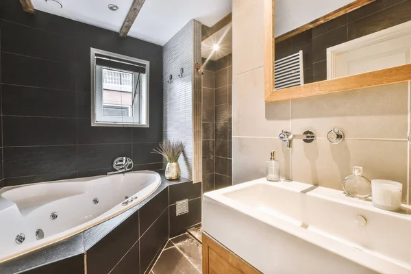 Modern styled bathroom with a bath and white double sink