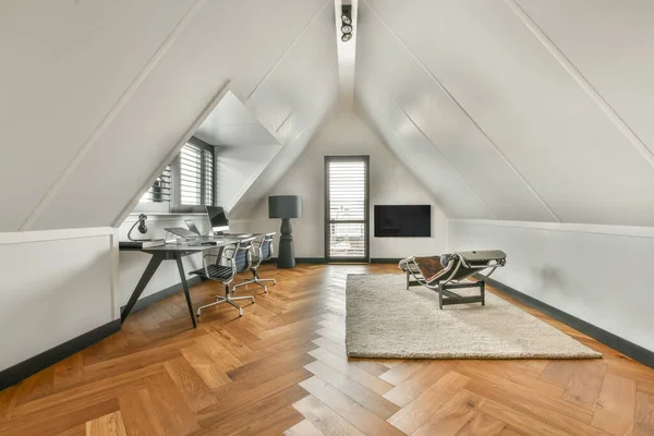 Spacious bright attic room for work and relaxation with a beautiful view from the window