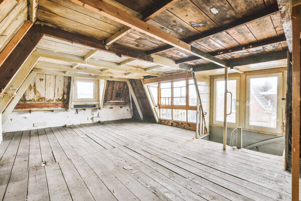 Plastic window on white wall in empty mansard light room at home
