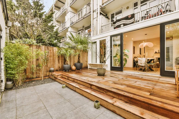 Backyard Deck of modern European house. High quality photo. Wooden deck with cloudy skies and green trees