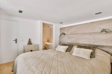 Geniş yataklı ve geniş pencereli, hafif yatak odasının içi.