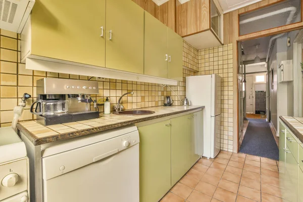 Spacious bright kitchen with wooden walls and tiled floor