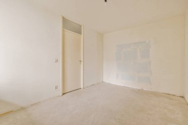 Evdeki boş ışık odasında, beyaz duvardaki plastik pencere ve radyatör.