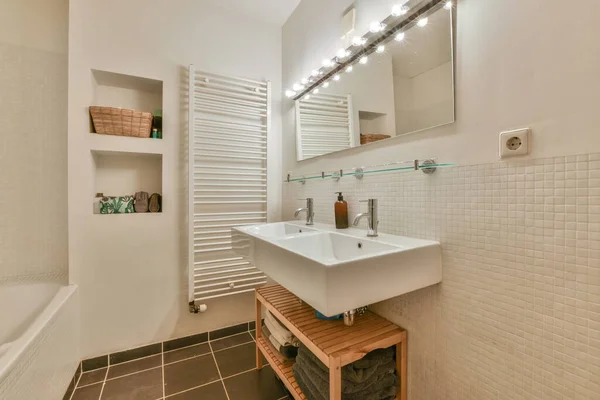 Interior of contemporary bathroom with shabby beige walls and partitions and white door at home