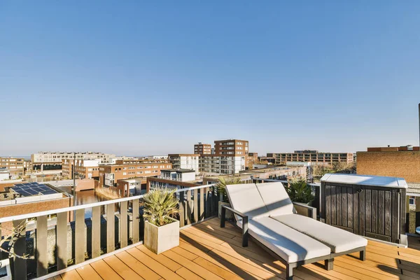 Panoramic view of the city from the roof of an apartment buildingPanoramic view of the city from the roof of an apartment building with sun loungers on a sunny day