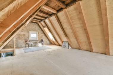 A cozy and spacious mansard styled empty room in a luxury house