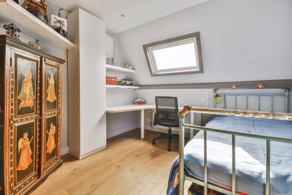 Minimalist interior design of small bedroom with soft bed placed in corner and wooden wardrobe and shelves with lamp illumination