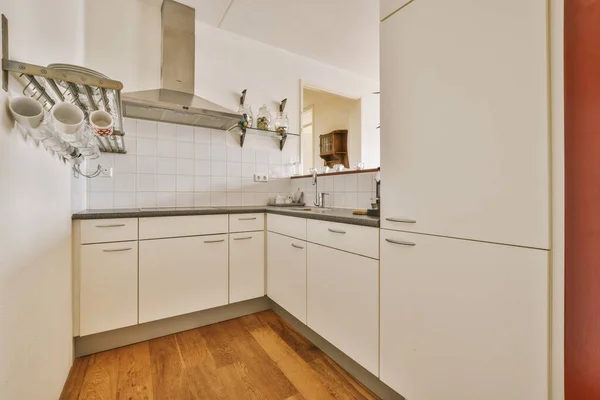 Counter with dividing kitchen with modern furniture from dining area in contemporary flat