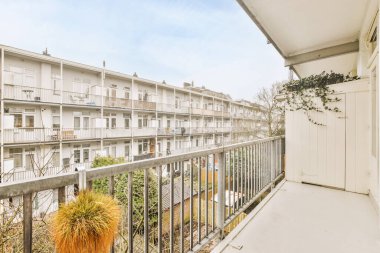 Korkuluklu küçük balkondan eski tuğla binaların önü.