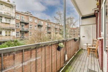 Eski tuğlalı binaların ve bisikletli arabaların ön manzarası küçük balkondan tırabzanlara kadar uzanıyor.