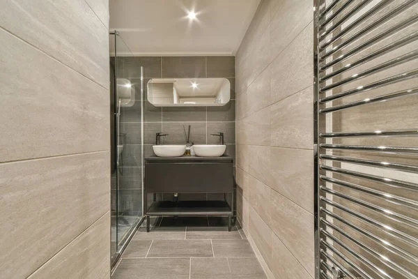 Interior of contemporary bathroom with shabby beige walls and partitions and white door at home