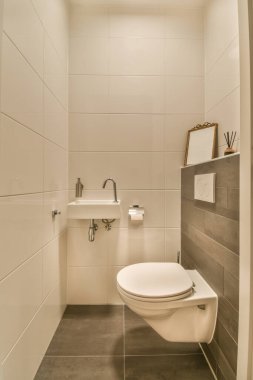 Interior of contemporary bathroom and restroom with shower , toilet and marble walls in minimal style flat