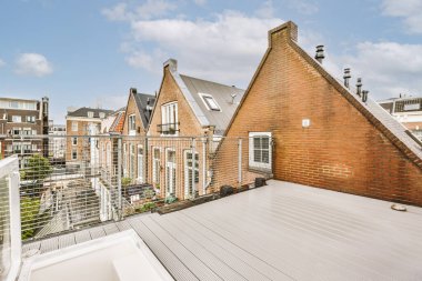 Bright wooden balcony with metal railings and door
