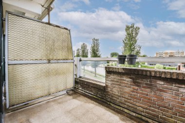Narrow brick balcony with brick railings and door