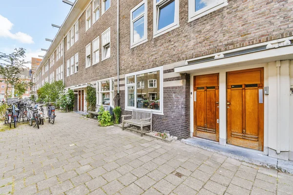 Front View Brick Building Signs Pavement Wooden Doors Lead Apartment — Photo