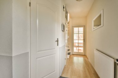 Işık dar koridor, beyaz duvarlarda birçok kapı ve kereste zemininde parlayan lamba