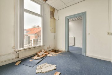 Büyük balkon pencereli, perdeli ve ahşap parke zeminli boş beyaz odanın içi.