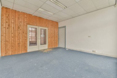 Büyük balkon pencereli, perdeli ve ahşap parke zeminli boş beyaz odanın içi.