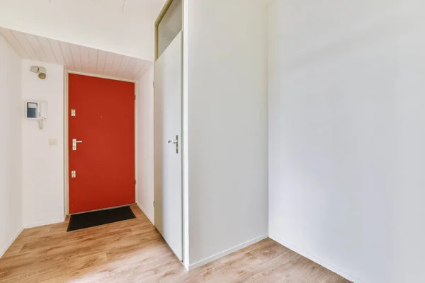 Corridor of contemporary apartment with doorway leading to terrace