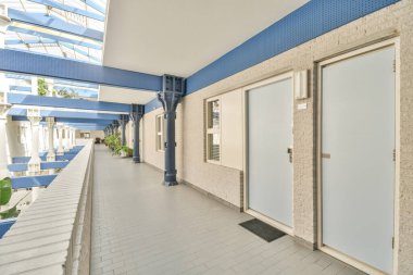 Corridor of contemporary apartment and opened doorway leading to terrace