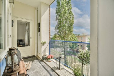 Sitting area in balcony with comfortable furniture around beautiful view