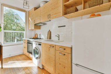 Studio apartment with white walls and open plan kitchen with sofa in living room