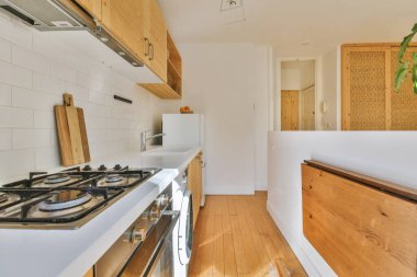 Studio apartment with white walls and open plan kitchen with sofa in living room