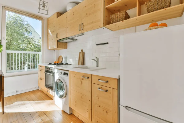 Studio apartment with white walls and open plan kitchen with sofa in living room