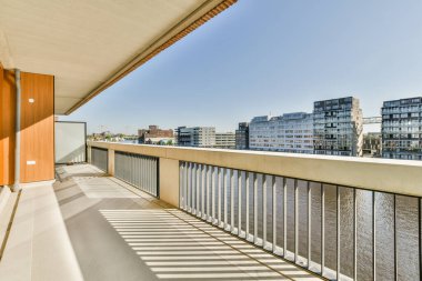 Panoramic view of old buildings with parking and trees from small balcony