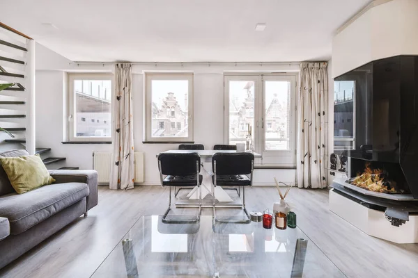 Interior of spacious room with chests of drawers in apartment designed in minimal style