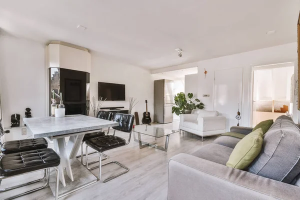 Interior of spacious room with chests of drawers in apartment designed in minimal style