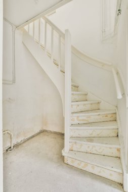 Light hallway in apartment with staircase leading upstairs in daylight
