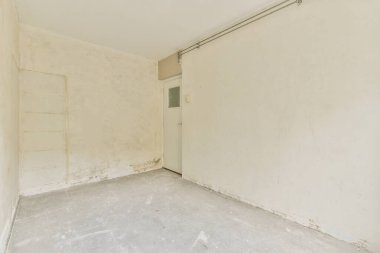 Plastic window and radiator in empty light room at home