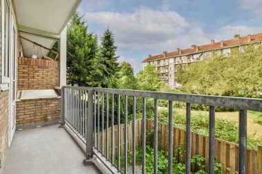 Panoramic view of buildings with trees from small balcony