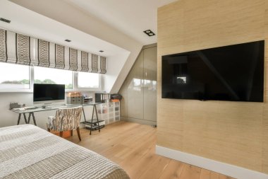 Comfortable bed and furniture in modern minimalist style mansard bedroom with panoramic windows