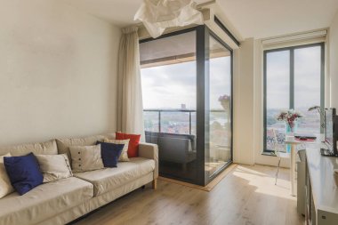 Sofa square table placed,books and TV in stylish living room of contemporary apartment.