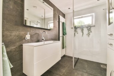 shower tap and wall hung toilet in modern restroom at home