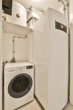 contemporary laundry with a stacked washer/dryer and